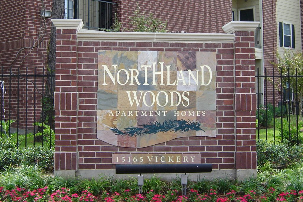 An image of the Nortland Woods Apartment Homes brick sign at the entrance of the property.