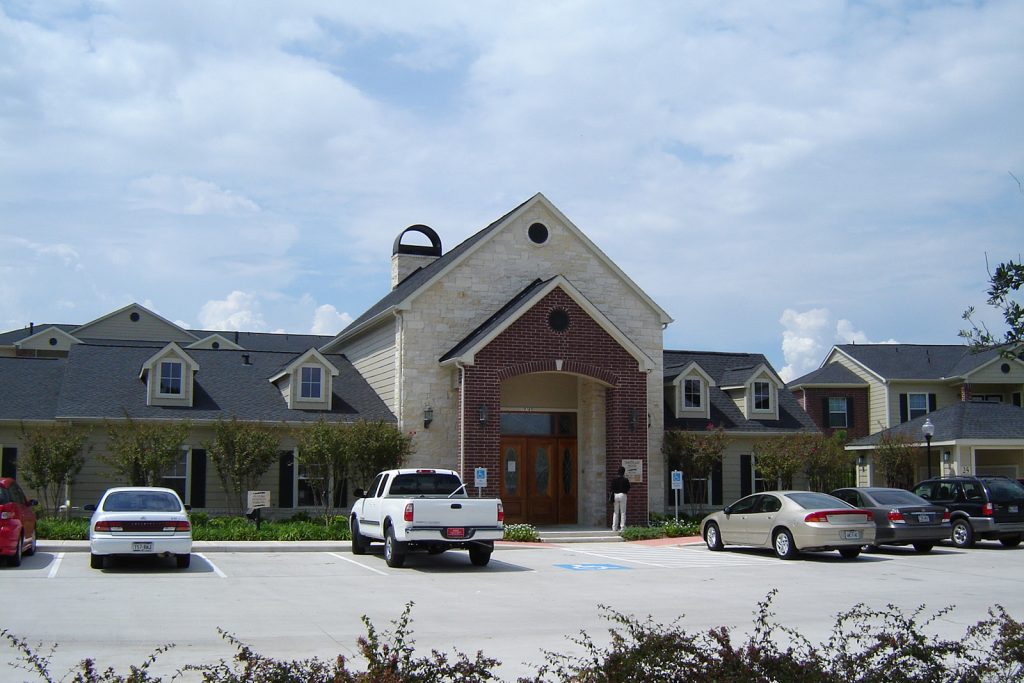 Front view of the Northland Woods main office. Parking lot with a few cars parked.